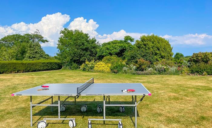 The lawn at Ysgubor Degwm Holiday Let self catering in North Wales between Criccieth and pwllheli with a butterfly garden rollaway table tennis table.